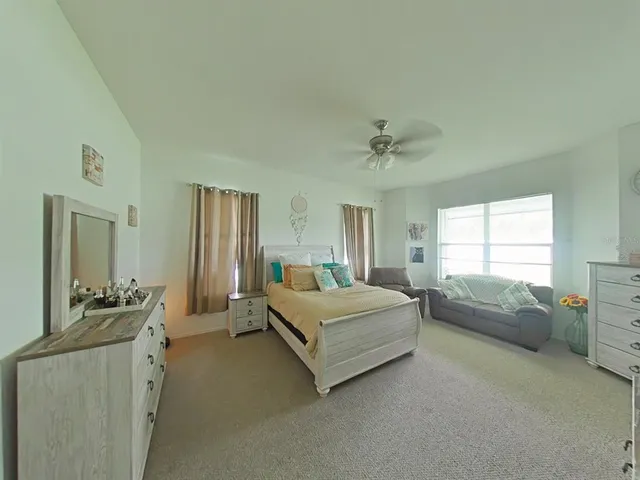 a view of a bedroom with bed window and a bathroom