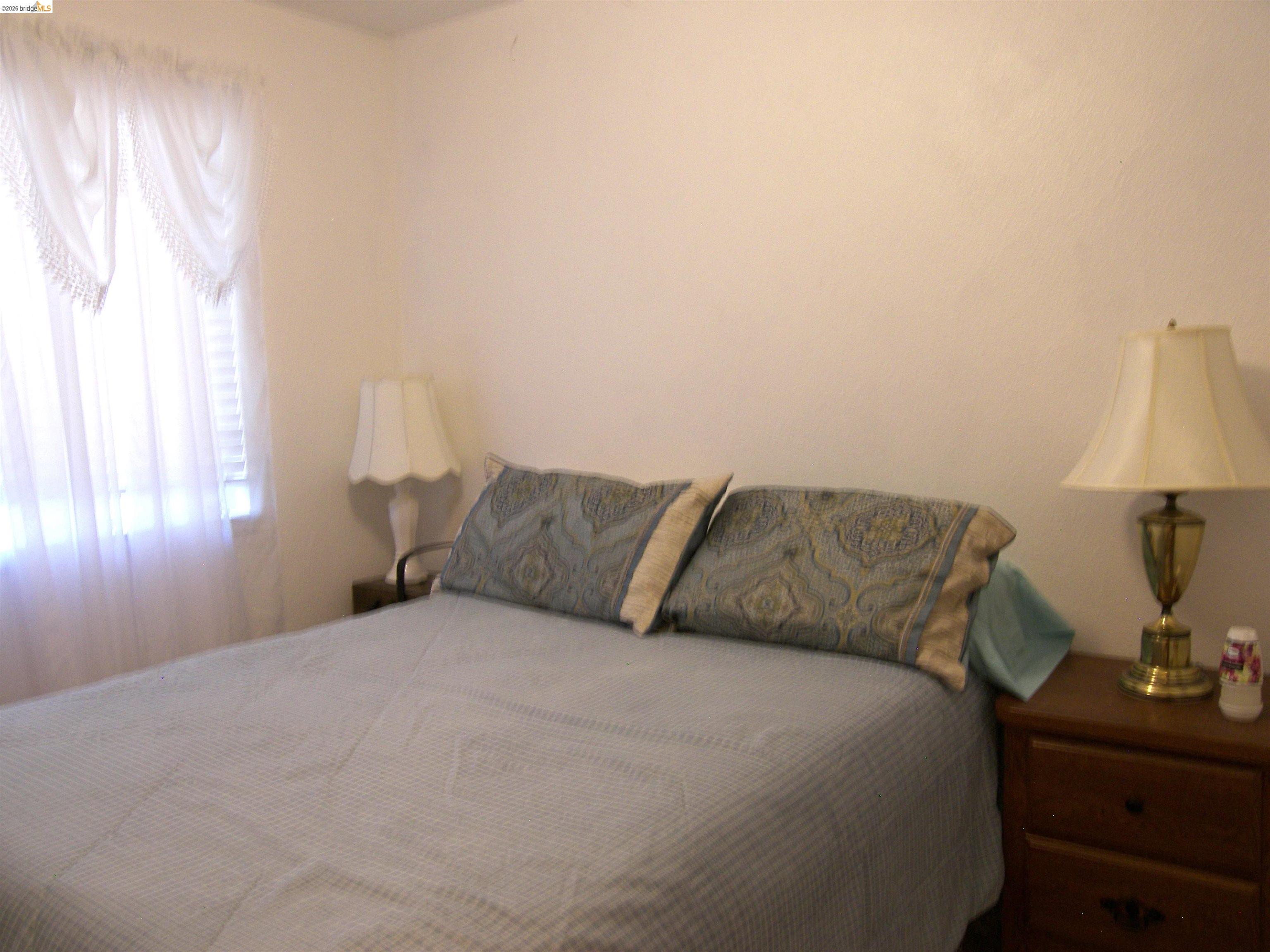 19215 Ferretti Road Groveland, CA 95321 - Photo 15 of 40 Bright bedroom with sheer curtains.