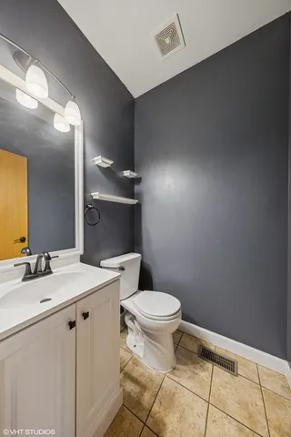 a bathroom with a sink toilet and mirror