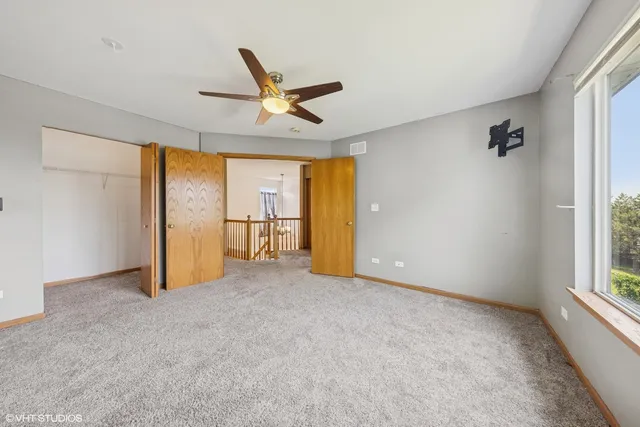 a spacious bedroom with a bed and a window