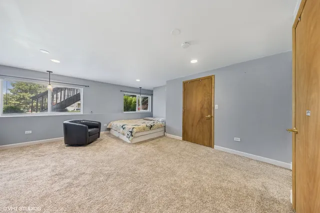 a spacious bedroom with a bed and a cabinets