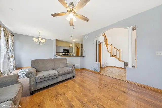 a living room with furniture and a chandelier