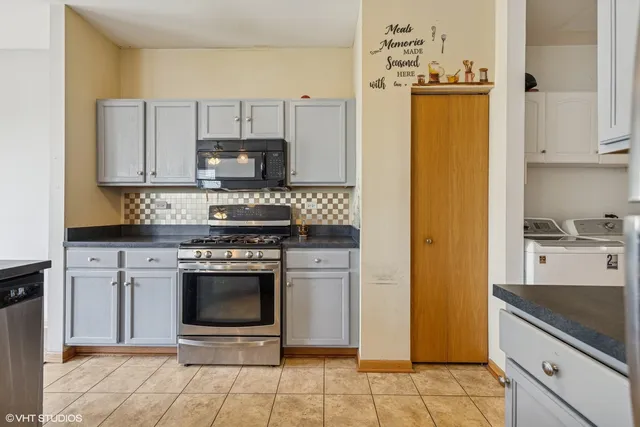 a kitchen with stainless steel appliances granite countertop a stove a microwave and a refrigerator
