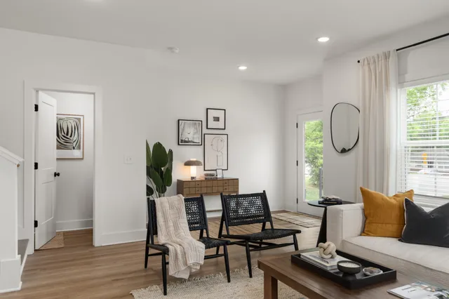 a living room with furniture rug and window