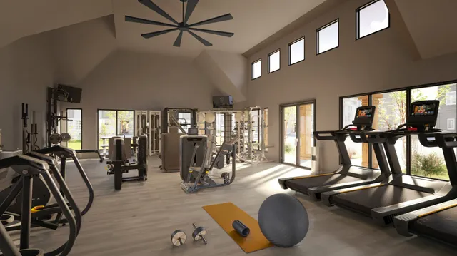 a room with gym equipment and windows
