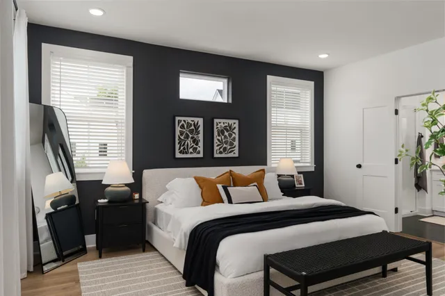 a bedroom with a bed and wooden floor