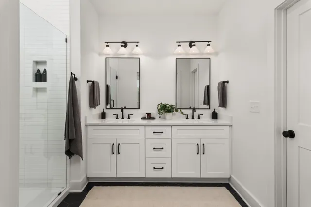 a spacious bathroom with double sink and a mirror