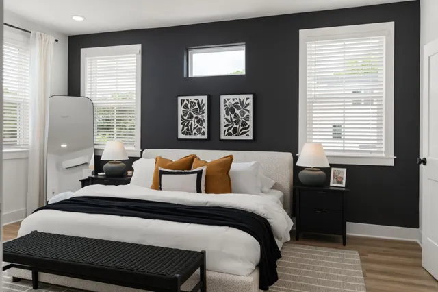 a bedroom with a bed and wooden floor