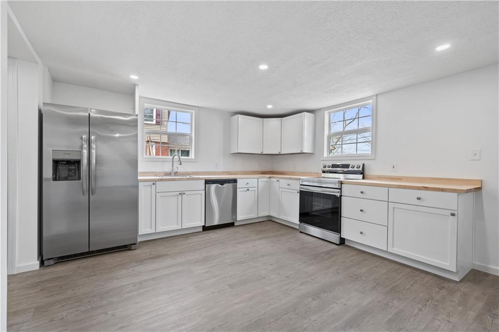215 Wendel Road Irwin, PA 15642 - Photo 7 of 25 a kitchen with white cabinets and white appliances