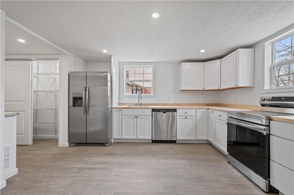 215 Wendel Road Irwin, PA 15642 - Photo 9 of 25 a kitchen with white cabinets and stainless steel appliances