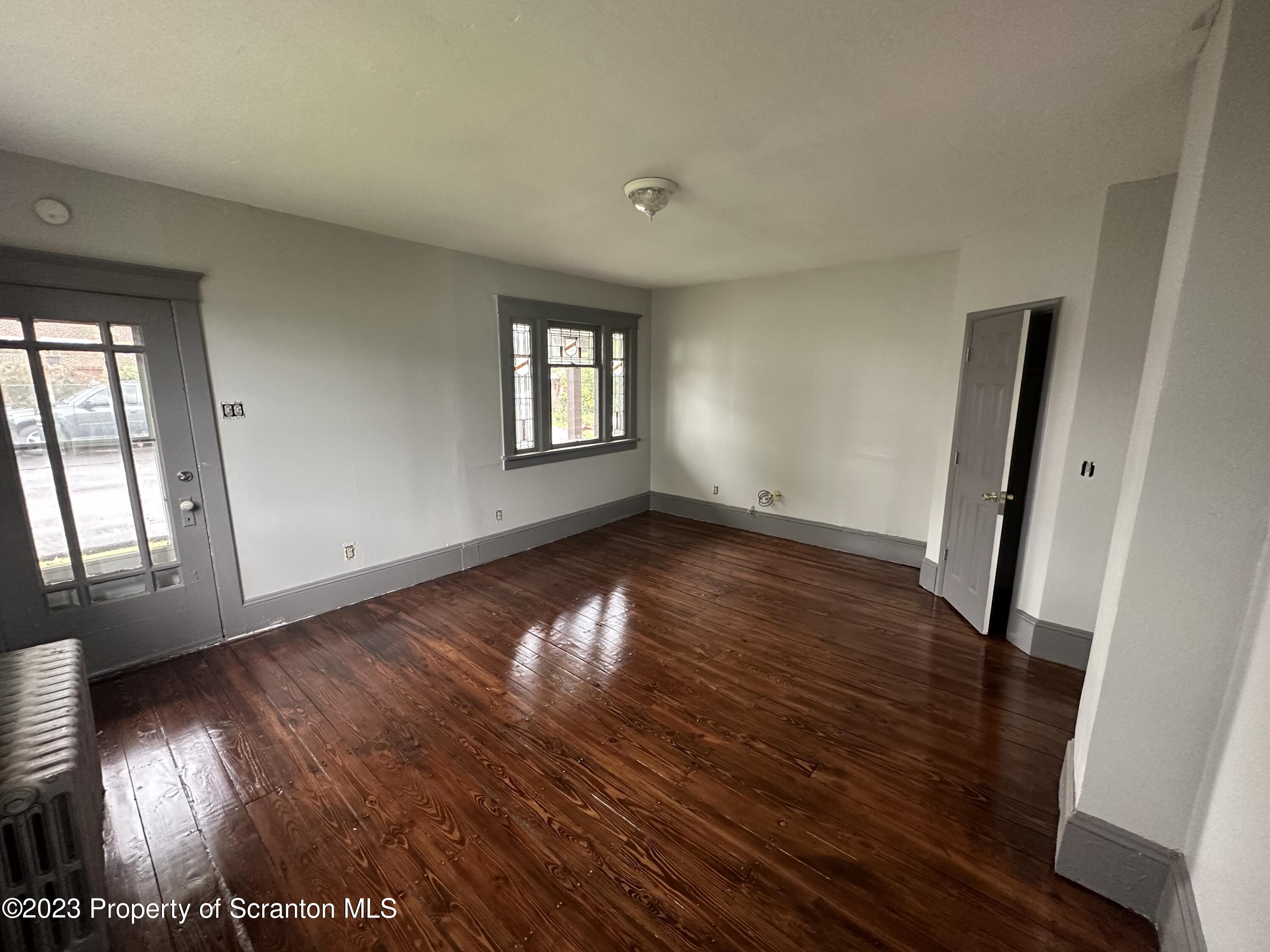 930 South Hanover Street Nanticoke, PA 18634 - Photo 3 of 9 wooden floor in an empty room with a window