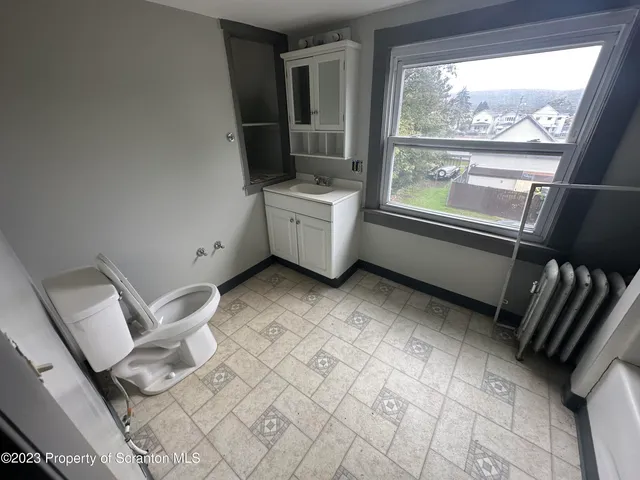 a view of a hardwood floor and staircase