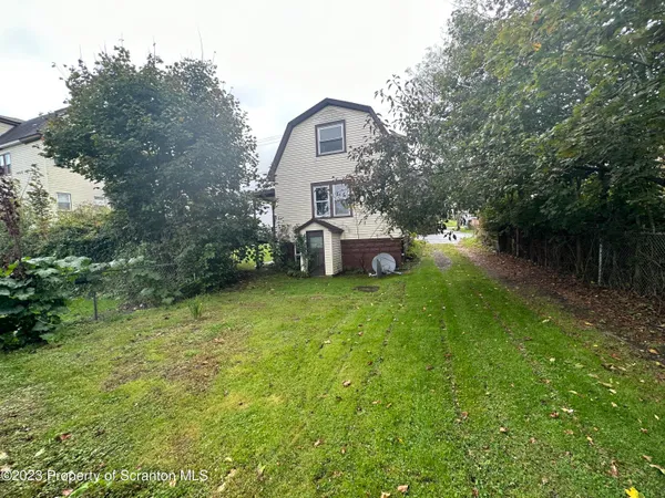 a view of a house with a yard and sitting area