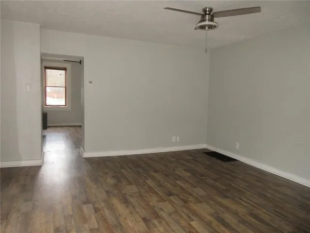 wooden floor in an empty room with a window