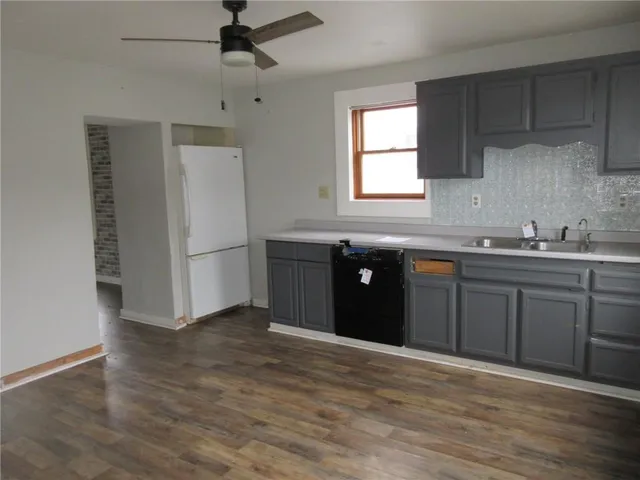 a kitchen with a sink and a refrigerator