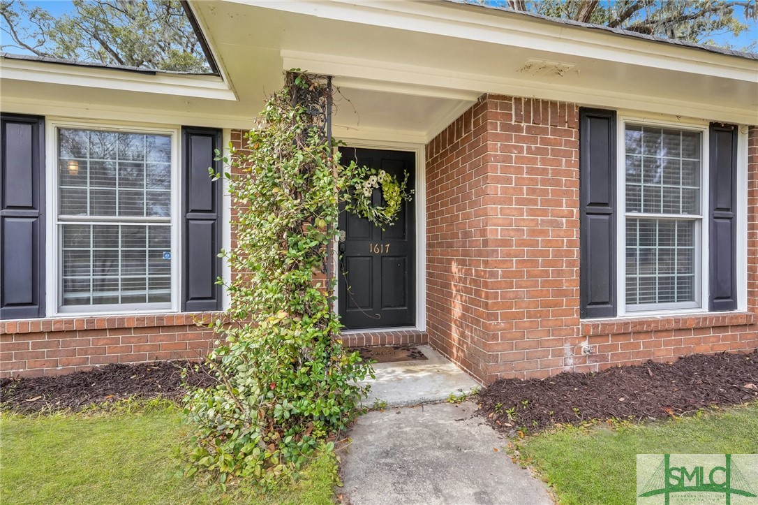 1617 Walthour Road Savannah, GA 31410 - Photo 2 of 38 Jasmine drapes over the front entrance