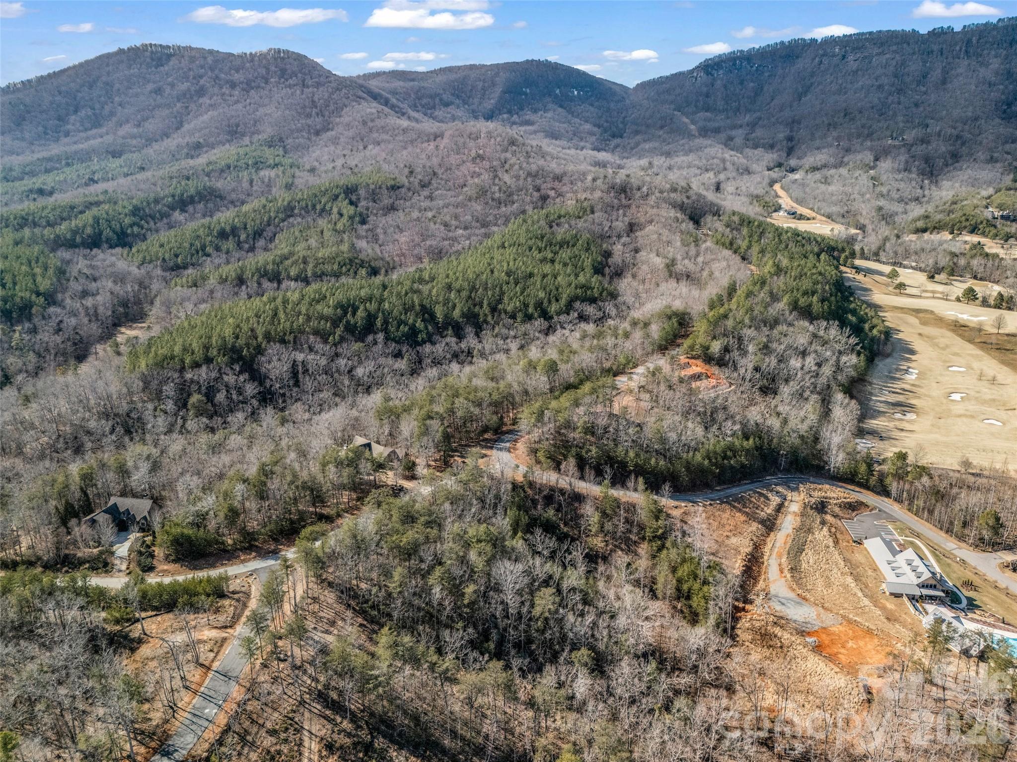 2002 Deep Gap Farm Road East Mill Spring, NC 28756 - Photo 7 of 33 a view of a dry yard with mountains in the background