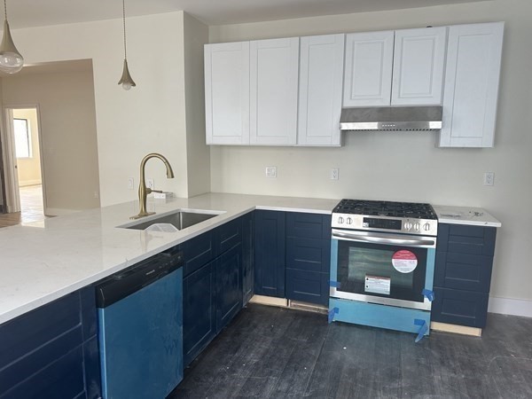 106 Rosseter Street, Unit 3 Boston, MA 02121 - Photo 2 of 9 a kitchen with stainless steel appliances granite countertop a sink and a stove