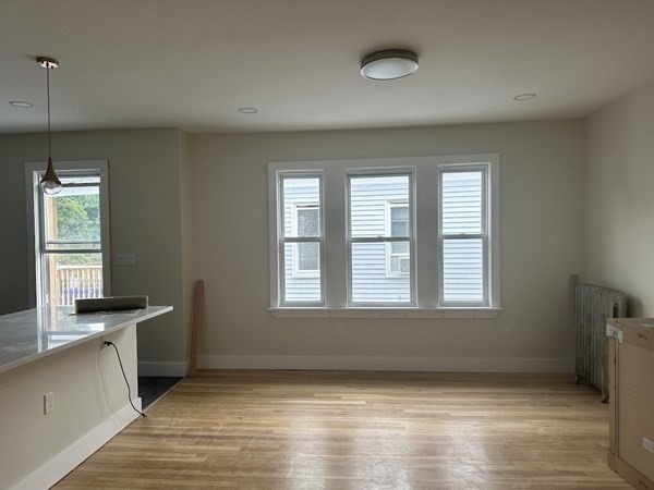 106 Rosseter Street, Unit 3 Boston, MA 02121 - Photo 3 of 9 a view of an empty room with a window