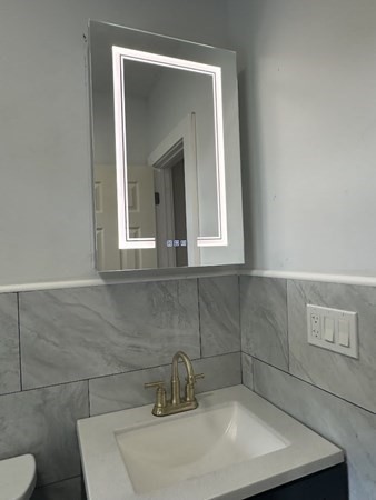 106 Rosseter Street, Unit 3 Boston, MA 02121 - Photo 4 of 9 a bathroom with a sink and a mirror