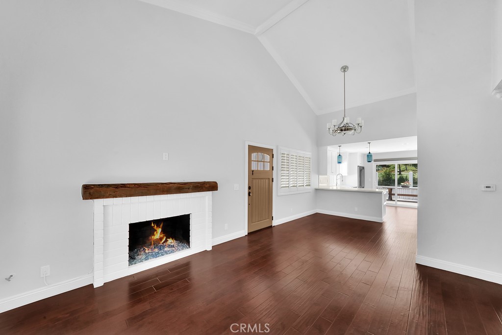 33902 Faeroe Bay Dana Point, CA 92629 - Photo 8 of 22 a view of empty room with wooden floor and fireplace