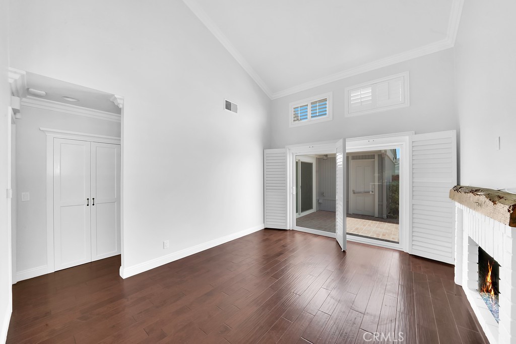 33902 Faeroe Bay Dana Point, CA 92629 - Photo 10 of 22 an empty room with wooden floor and fireplace