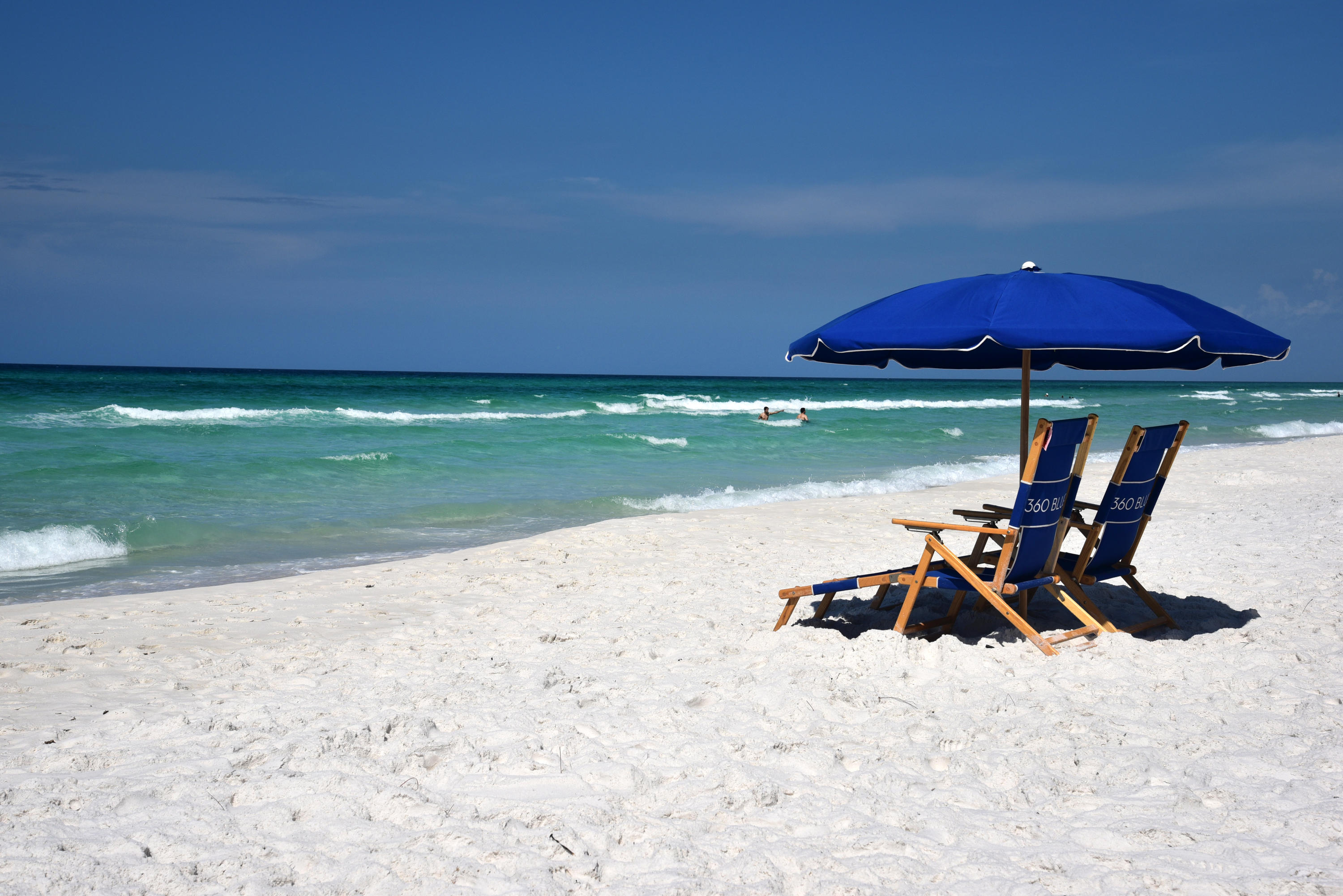 a view of a backyard with a table and chairs under an umbrella