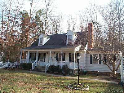 7375 River Road Hanover, VA 23069 - Photo 1 of 1 a house that has tree in front of it