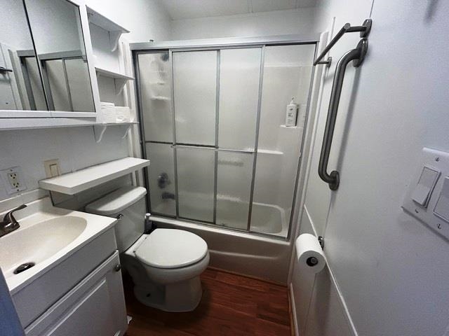6 Robin Avenue Myrtle Beach, SC 29572 - Photo 12 of 24 Bathroom with vanity, dark wood finished floors, and bath / shower combo with glass door
