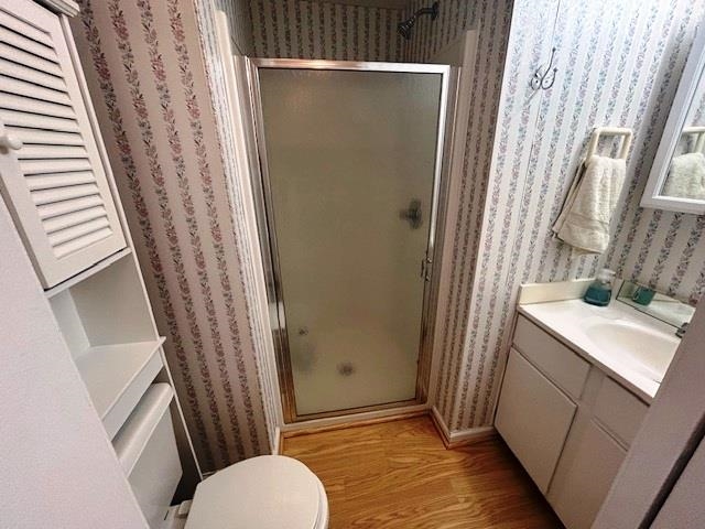 6 Robin Avenue Myrtle Beach, SC 29572 - Photo 13 of 24 Bathroom featuring a shower stall, vanity, light wood-type flooring, and wallpapered walls