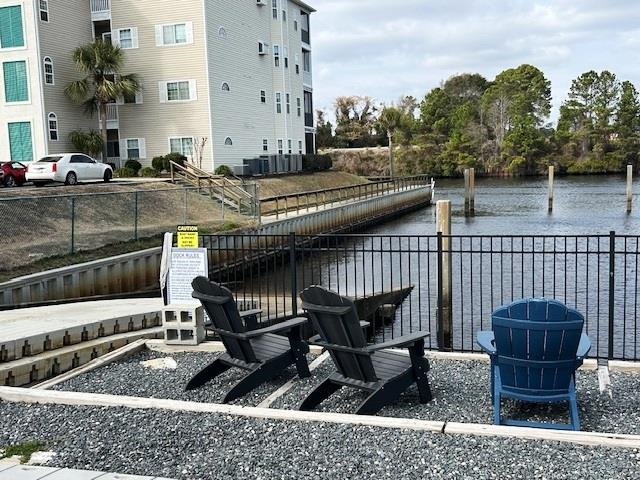 6 Robin Avenue Myrtle Beach, SC 29572 - Photo 19 of 24 View of patio / terrace with a boat dock and a water view