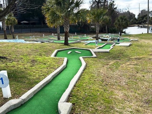 6 Robin Avenue Myrtle Beach, SC 29572 - Photo 24 of 24 Surrounding community with a putting green, a water view, and a yard