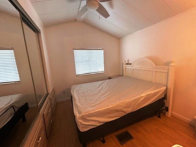 6 Robin Avenue Myrtle Beach, SC 29572 - Photo 10 of 24 Bedroom with vaulted ceiling, dark wood finished floors, a closet, and a ceiling fan