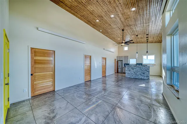 a living room with couches and kitchen view