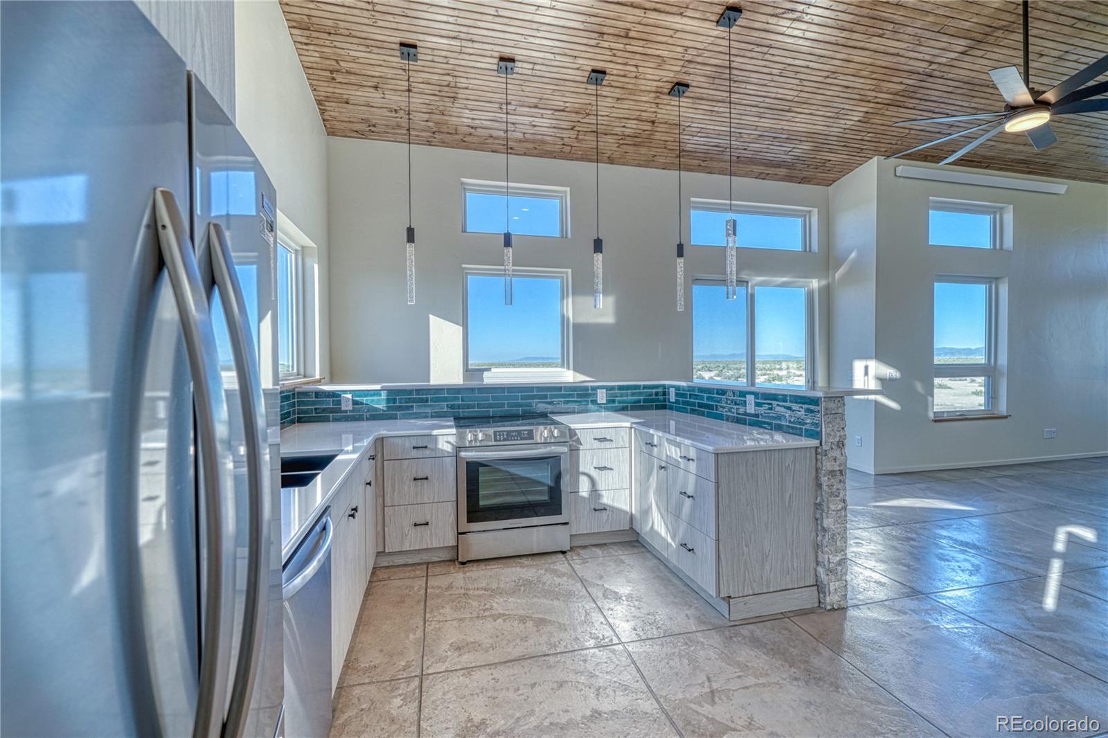 57884 Co Road Moffat, CO 81143 - Photo 22 of 40 a kitchen with stainless steel appliances granite countertop a refrigerator and a stove