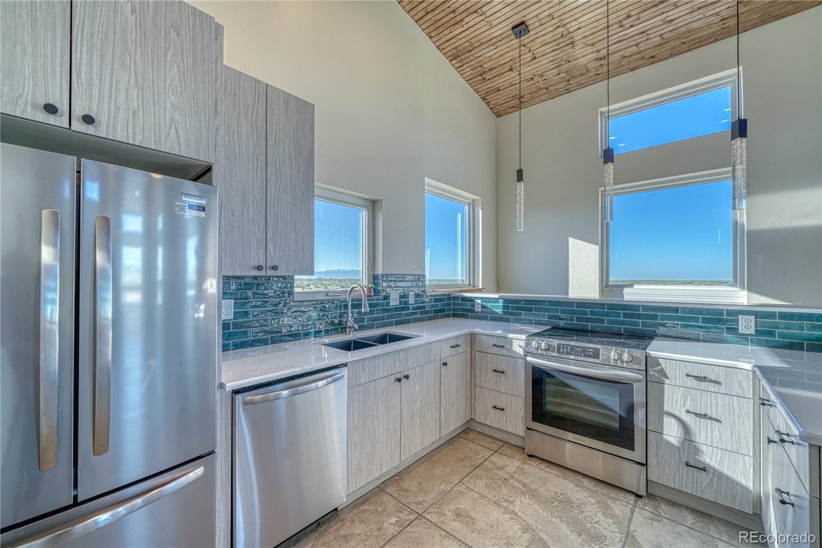 57884 Co Road Moffat, CO 81143 - Photo 23 of 40 a kitchen with a stove and a refrigerator
