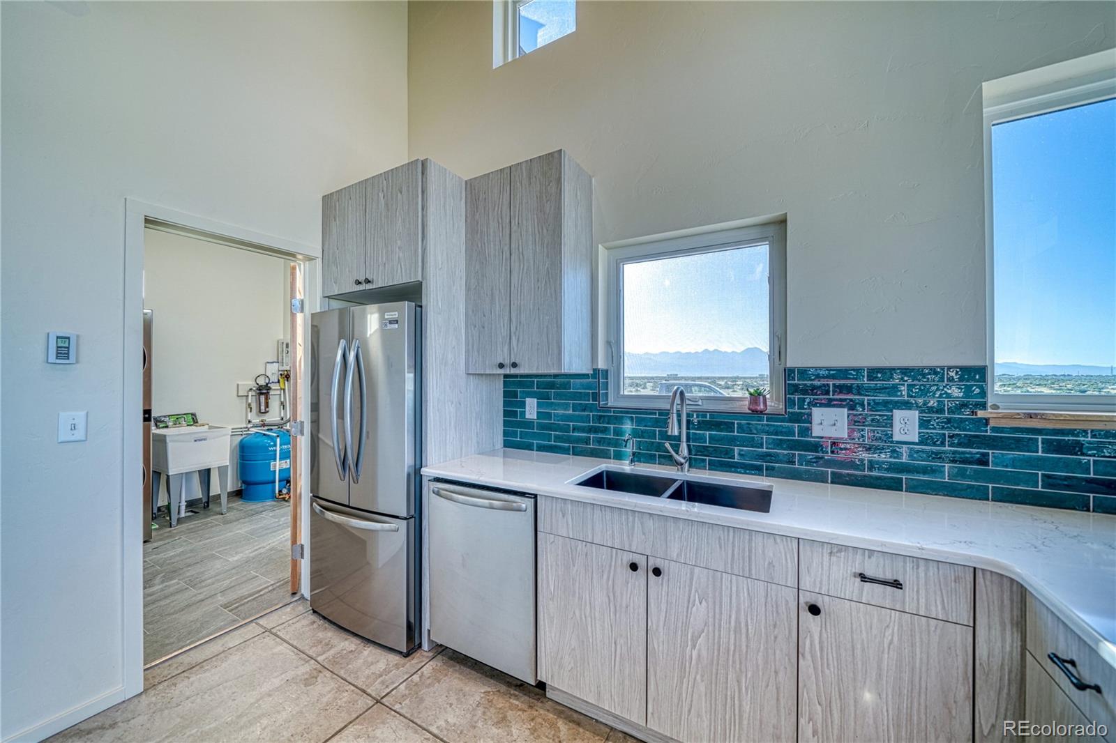 57884 Co Road Moffat, CO 81143 - Photo 24 of 40 a kitchen with a refrigerator and a sink