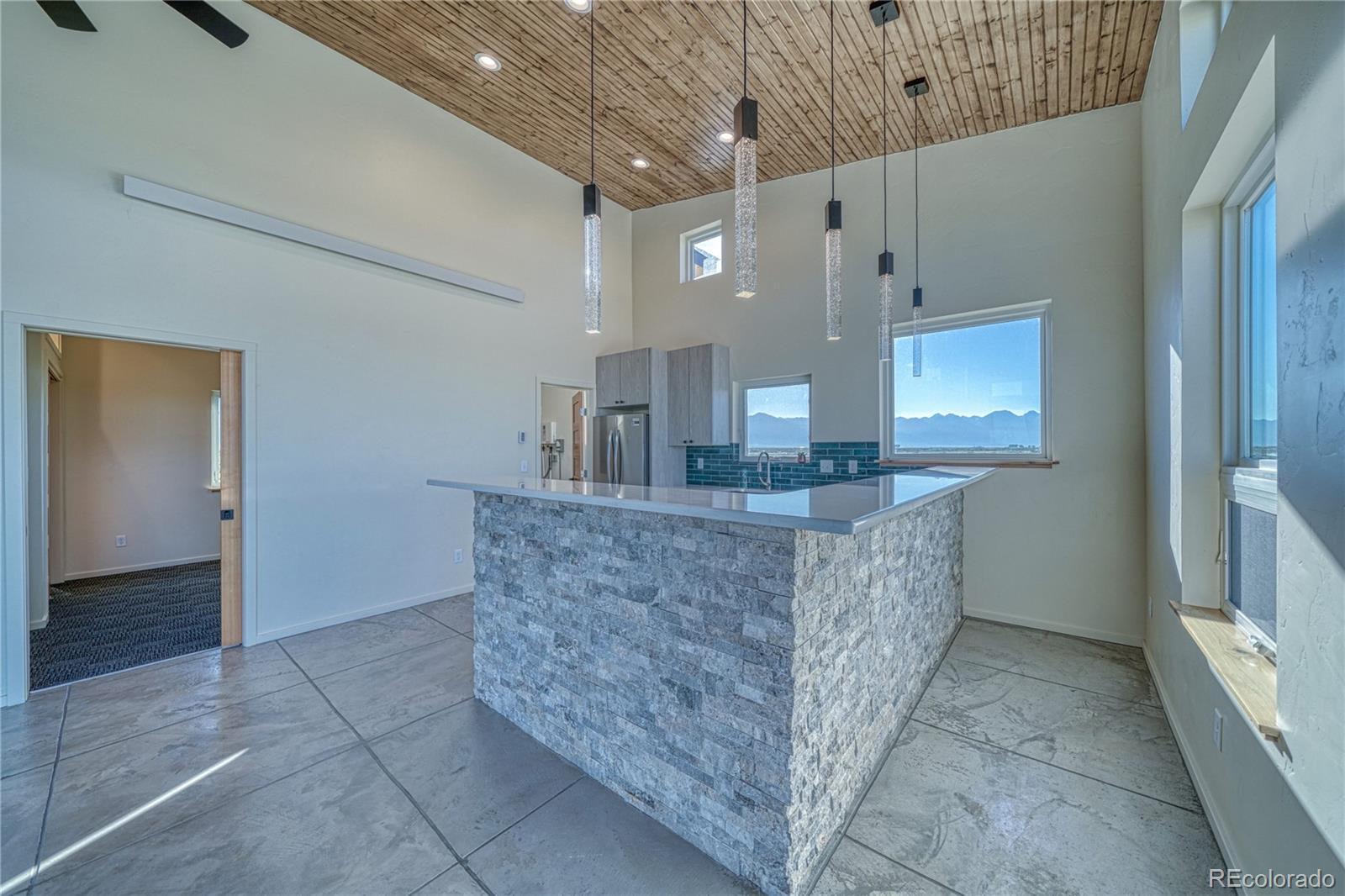 57884 Co Road Moffat, CO 81143 - Photo 27 of 40 a living room with granite countertop furniture and a fireplace