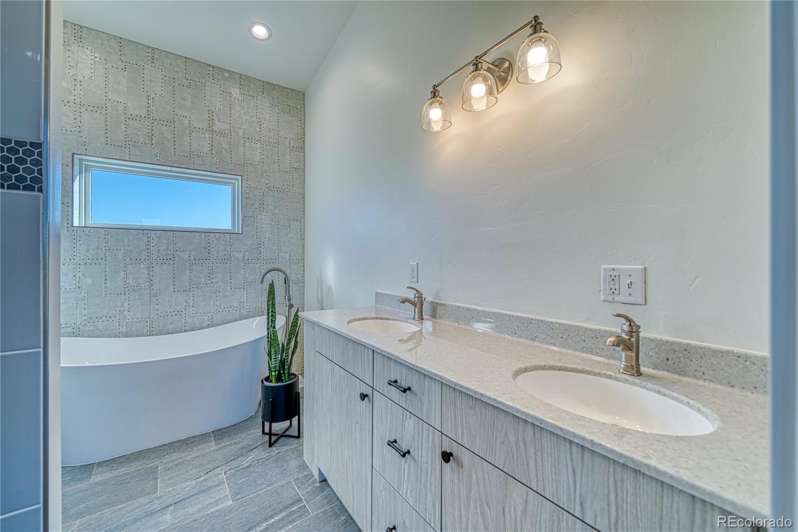 57884 Co Road Moffat, CO 81143 - Photo 30 of 40 a bathroom with a double vanity sink and a bathtub