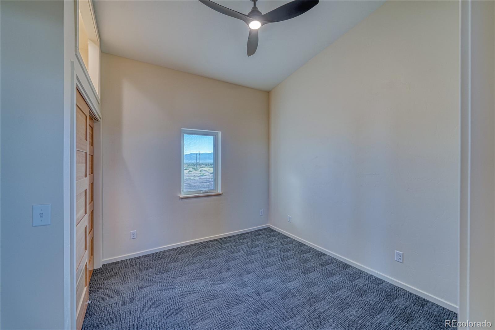 57884 Co Road Moffat, CO 81143 - Photo 33 of 40 a view of a livingroom with a ceiling fan and window
