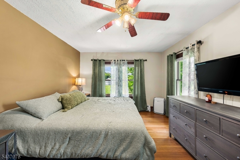 886 Brass Castle Road Belvidere, NJ 07823 - Photo 18 of 44 a bedroom with a large bed and a flat screen tv