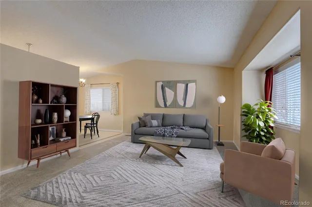 a living room with furniture and potted plant