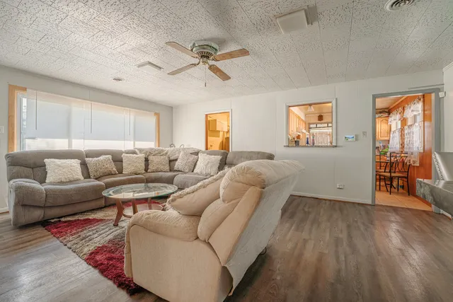 a living room with furniture and wooden floor