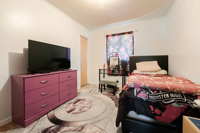 a bedroom with a bed and flat screen tv