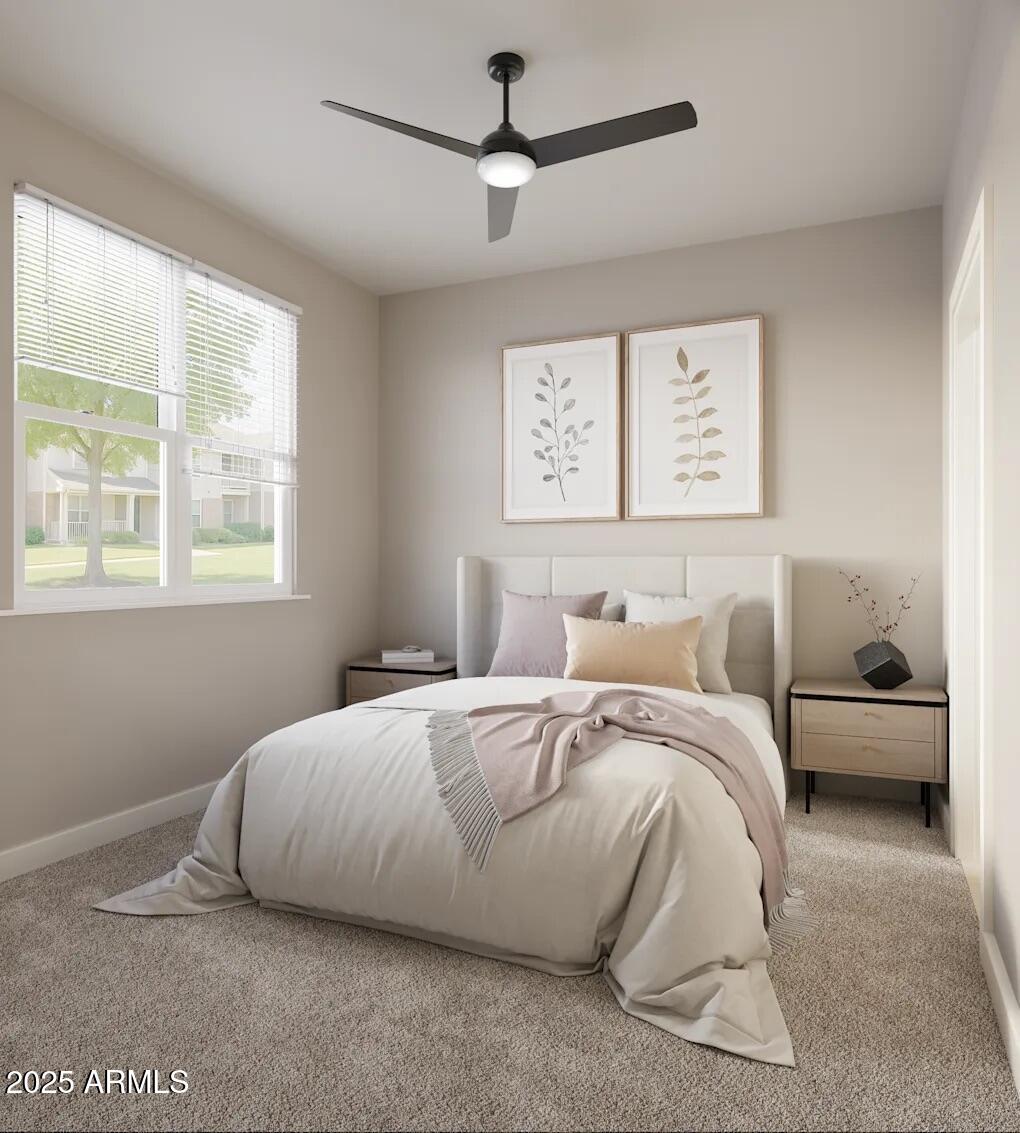 39696 West Lococo Street Maricopa, AZ 85138 - Photo 4 of 6 a spacious bedroom with a bed a couch and a window