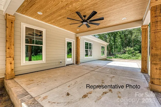 a view of a big room with wooden floor and a ceiling fan