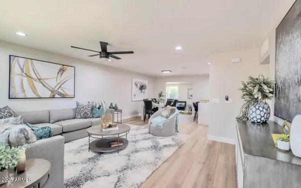 a living room with furniture a window and a chandelier