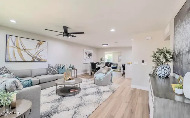 a living room with furniture a window and a chandelier