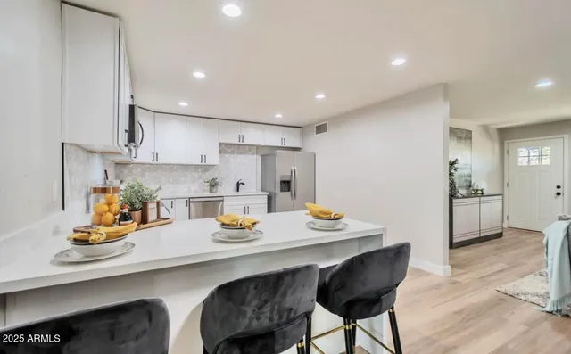 a kitchen with a sink a stove cabinets and counter space