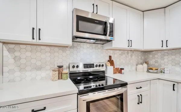a kitchen with cabinets and appliances